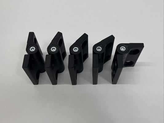 Five black metal hinges at different angles on a gray background