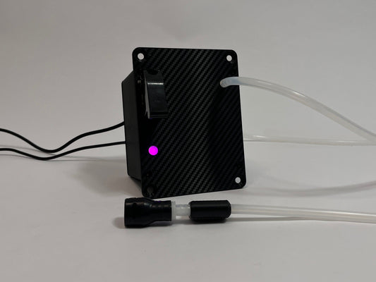 Sim Racing Hydration Device with carbon fiber front texture and purple LED burning. Silicone tubing and cables coming out on a light gray background