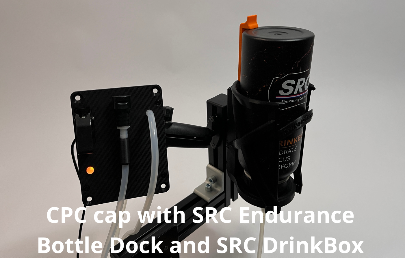 A SRC Endurance Bottle Dock with included bottle in it and SRC DrinkBox connected to tubing, shown against a plain light gray background with white text overlay at the bottom saying "CPC cap with SRC Endurance Bottle Dock and SRC DrinkBox".