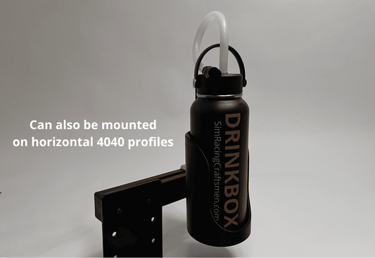 A black Drinkbox insulated water bottle with a white straw, shown mounted on a black metal bracket. White text on the left reads 'Can also be mounted on horizontal 4040 profiles'.