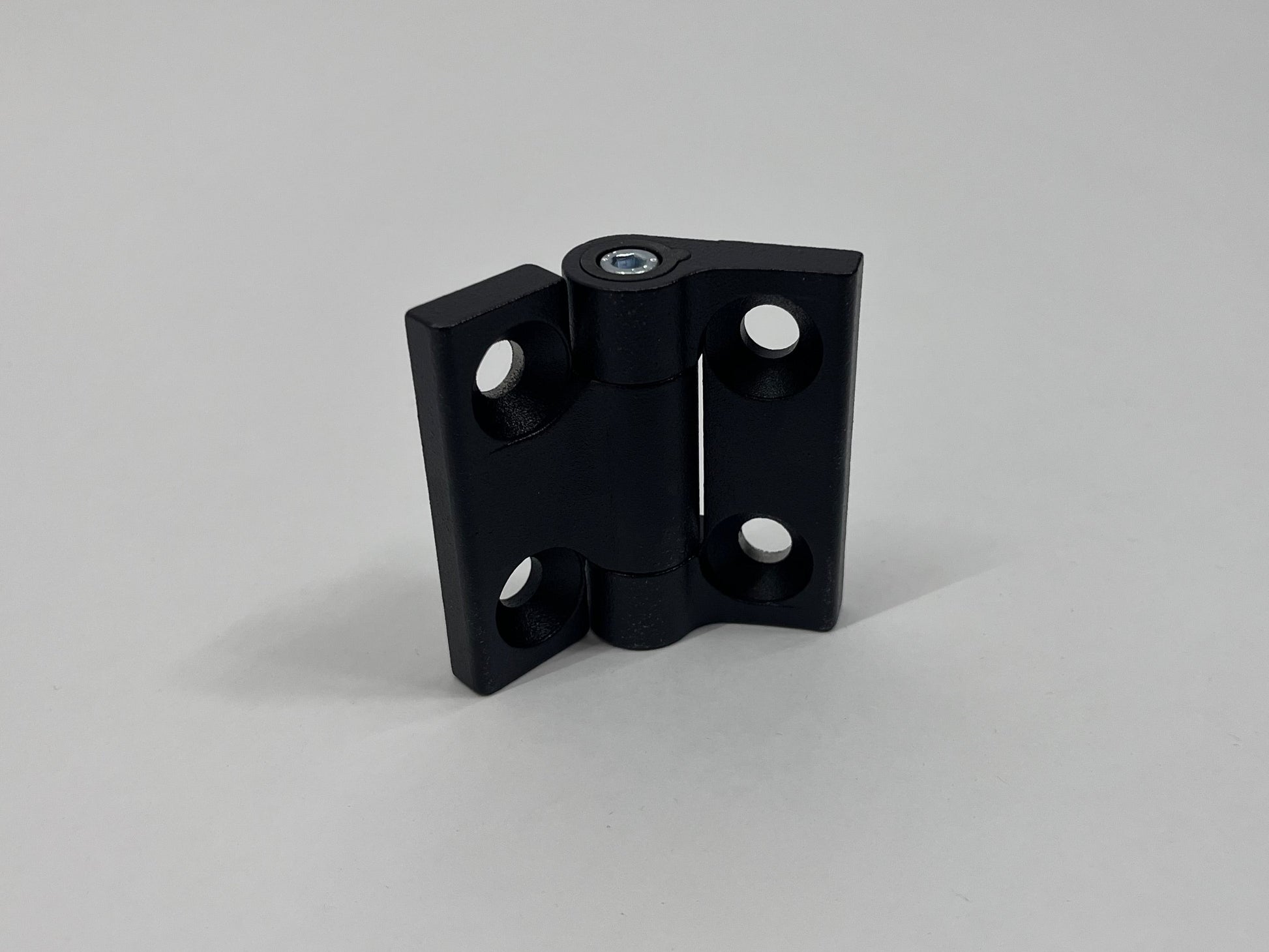 Black metal hinge on a gray background