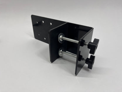 desk mount laying on surface to show underside of two knobs on threaded rods