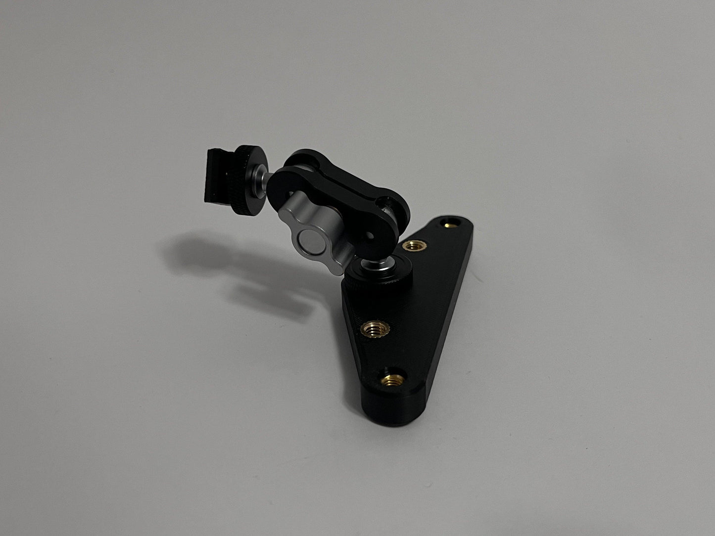 mini mount on top bottom adapter laying on white background