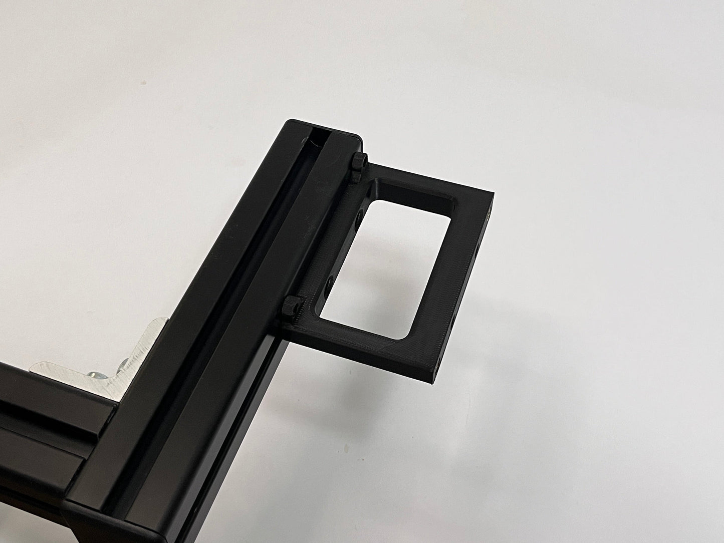 top view of sim racing button box black plastic solid mount mounted on a 4040 aluminum profile