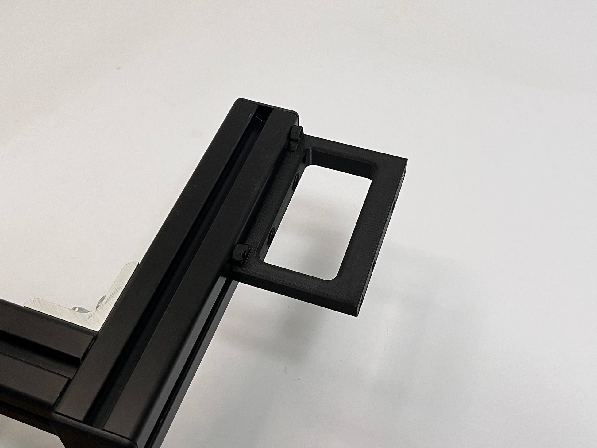 top view of sim racing button box black plastic solid mount mounted on a 4040 aluminum profile