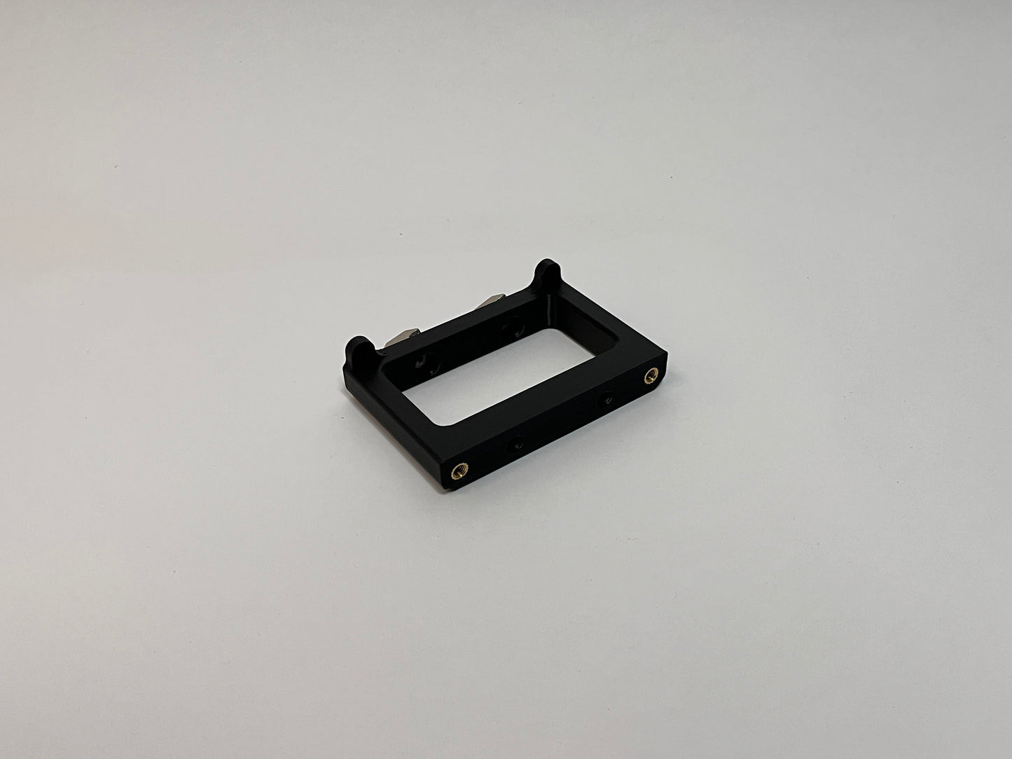 front side view of the button box solid mount showing 4040 profile mounting hardware installed on the mount on a white background