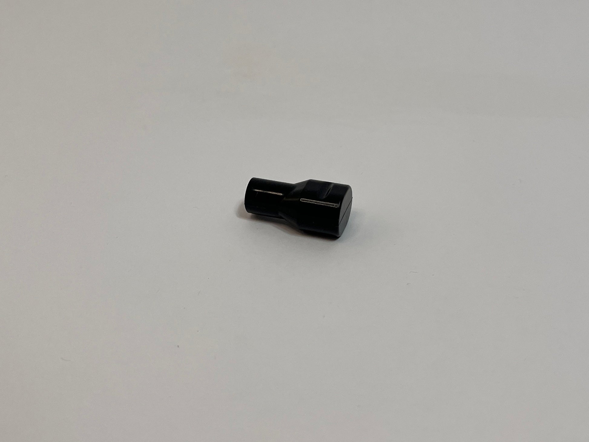 Black Silicone Bite valve sitting on a white background