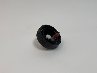 CPC cap showing the inside of the cap with white cpc fitting and red duckbill valve on a white background