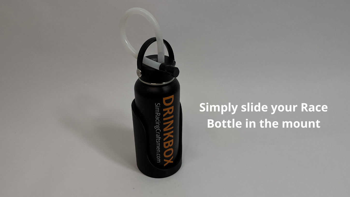 A black Drinkbox water bottle with a clear straw and a black mounting clip, shown on a light gray background with white text that reads 'Simply slide your Race Bottle in the mount'.