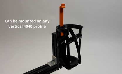 Black lattice bottle cage for sim racing based on real racing version mounted on 4040 profile, shown on a light gray background with white text that reads 'Can be mounted on any vertical 4040 profile'.
