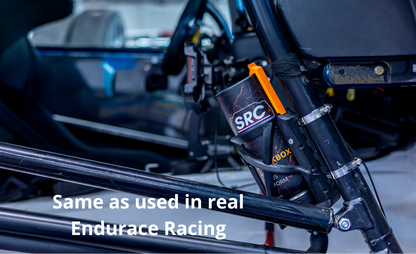 SRC Racing Bottle mounted in a SRC Endurance bottle dock mounted on a real roll cage. The photo is taken in a real racing environment with blurred seats and equipment in the background, and white text at the bottom reads 'Same as used in real Endurace Racing'.