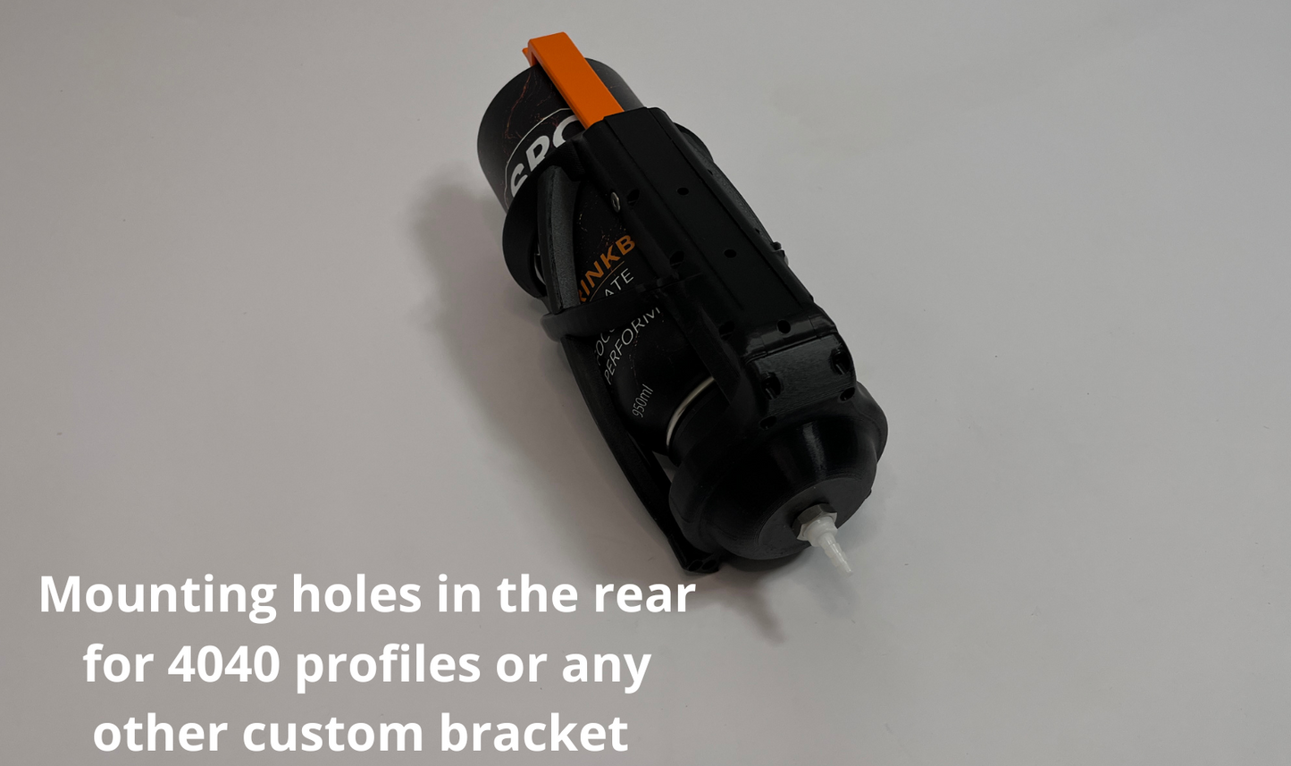 A black cylindrical sim racing hydration mounting bracket with an orange accent tab and white text, shown on a light gray background with white text overlay at the bottom stating 'Mounting holes in the rear for 4040 profiles or any other custom bracket'.