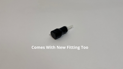 Black Silicone Bite valve with white plastic fitting for tubing in it on a white background