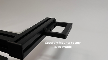 A close-up of a black Plastic button box mount showing its connection point with overlaid text that reads 'Securely Mounts to any 4040 Profile' on a light gray background.