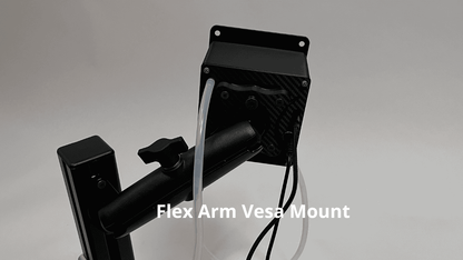 Black flex arm vesa mount hardware with a carbon fiber textured plate, black metal arm attached to a sim racing hydration system drinkbox, and white tubing and black cables, shown on a light gray background with a text overlay reading 'Flex Arm Vesa Mount'.