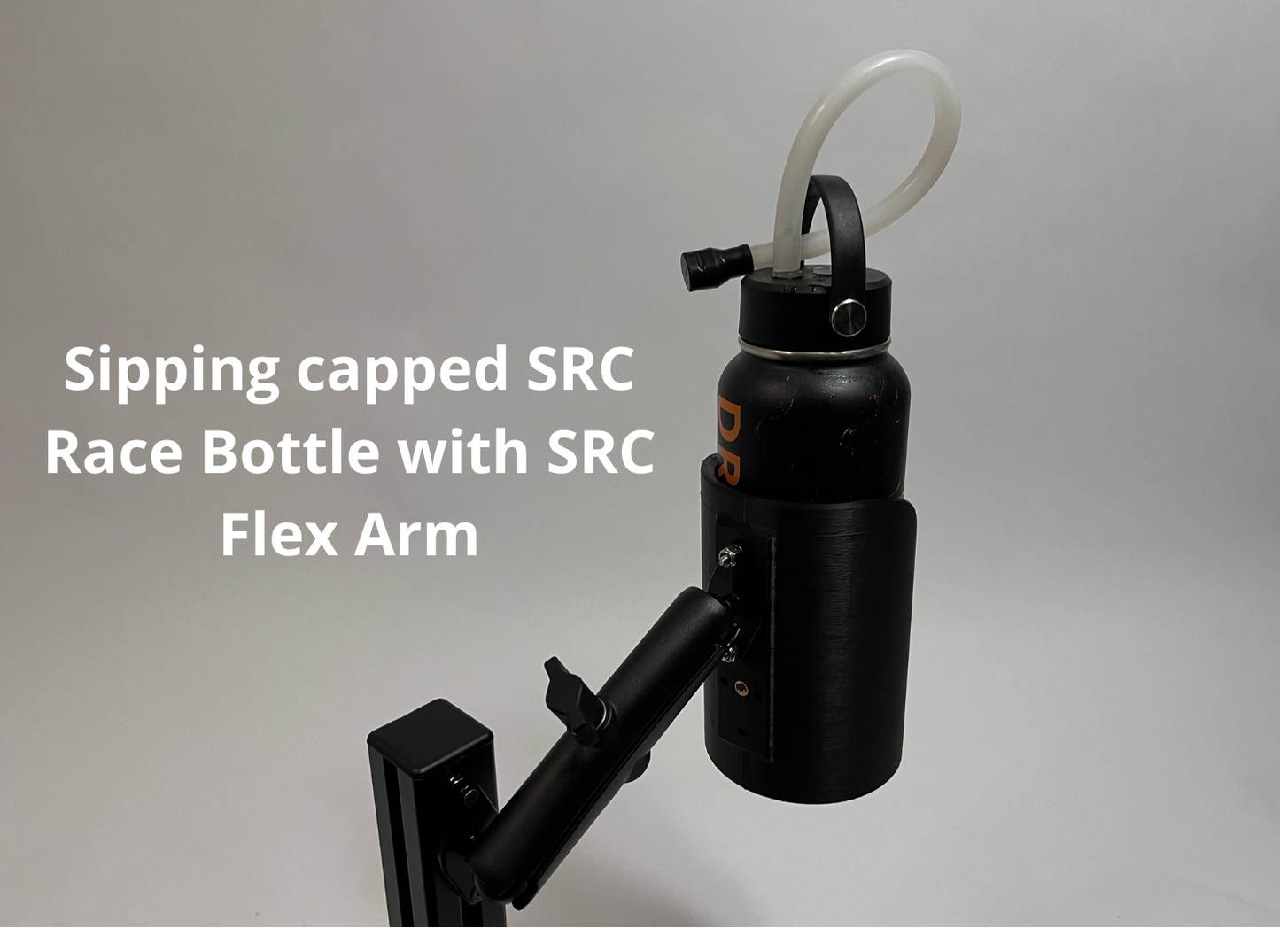 A black sipping-capped race bottle with a curved white straw and a black flex arm mount, shown against a light gray background with white text reading 'Sipping capped SRC Race Bottle with SRC Flex Arm'.