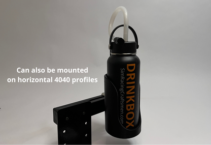 A black Drinkbox insulated water bottle with a white straw, shown mounted on a black metal bracket. White text on the left reads 'Can also be mounted on horizontal 4040 profiles'.
